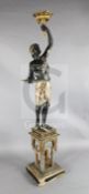 A 19th century Venetian painted and parcel gilt blackamoor torchere, the figure standing upon a