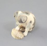 A Japanese walrus ivory netsuke of a puppy, 19th century, the puppy with textured fur details and