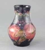 A Moorcroft pomegranate pattern baluster vase, height 6.75in.