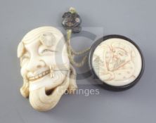A Japanese ivory noh mask netsuke and an erotic manju ivory and wood netsuke, late 19th / early 20th