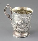 A Victorian embossed silver christening mug, James Charles Edington, decorated with a spaniel and