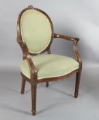 A set of eight Hepplewhite design mahogany elbow chairs, with blue silk fabric upholstery and carved