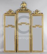 An early 20th century French giltwood and gesso set of three wall mirrors, with eagle crest and