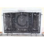 A large wrought iron and wire mesh chimneypiece spark guard, fitted with a pair of central doors,