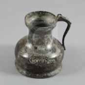 A 16th century Dutch or German pewter flagon, of bulbous form with side scroll handle, 9in., cover
