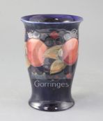 A Moorcroft pomegranate pattern trumpet vase, blue W Moorcroft signature, impressed marks and