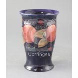 A Moorcroft pomegranate pattern trumpet vase, blue W Moorcroft signature, impressed marks and