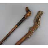 Two carved handled walking sticks longest 92cm