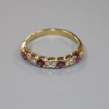 An 18ct gold, seven stone ruby and diamond half hoop ring, size P/Q.