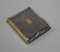 A shagreen and gilt metal cigarette case by Cartier, with gold monogram and cabochon ruby to thumb-