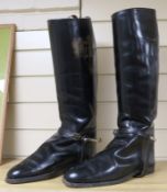 A pair of black leather riding boots and trees