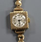 A lady's 9ct gold Excalibur manual wind wrist watch, on a 9ct gold bracelet.