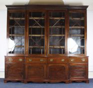 An Edwardian George III style mahogany breakfront library bookcase, with dentil cornice, blind