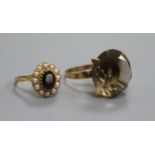 A 9ct gold and smoky quartz dress ring and a 9ct gold garnet and seed pearl oval cluster ring.