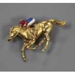 A 9ct gold and enamel horse and jockey brooch (a.f.), 37mm.