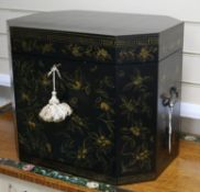 A Japanese lacquered small chest with canted corners, all-over decorated with gilt flowers and