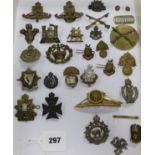 A collection of twenty five assorted cap and other uniform badges and two small buttons