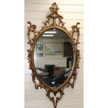 A pair of carved gilt-framed oval wall mirrors W.67cm