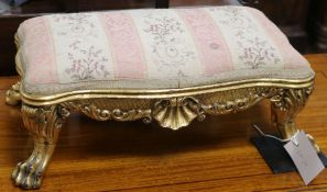 A carved and gilt mahogany footstool W.41cm