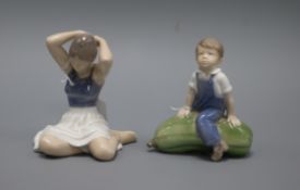 A Royal Copenhagen model of a seated ballerina, number 4648, and another of a boy sitting on a