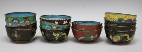 A collection of cloisonne rice bowls, including a set of four decorated with dragons, five others