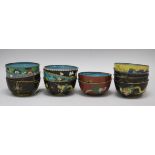 A collection of cloisonne rice bowls, including a set of four decorated with dragons, five others