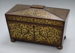 A Regency rosewood two-division tea caddy, of sarcophagus form inlaid with cut brasswork (two