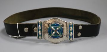 A George V Art Nouveau Liberty & Co planished silver and enamel buckle mounted on a leather belt,