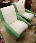 A pair of 1960's green and cream upholstered armchairs