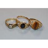 A 9ct gold tiger's eye ring, a gem-set 10ct gold ring and a 9ct gold and diamond textured ring.