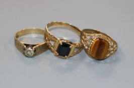 A 9ct gold tiger's eye ring, a gem-set 10ct gold ring and a 9ct gold and diamond textured ring.