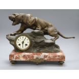 A spelter clock modelled as a tiger, on a marble base, signed T Cartier height 30cm