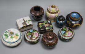 A collection of cloisonne covered jars and boxes, including a pair of circular black ground boxes