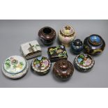 A collection of cloisonne covered jars and boxes, including a pair of circular black ground boxes