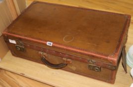 A brown canvas suitcase