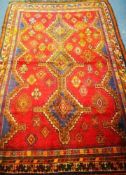 A Shiraz red ground rug 236 x 165cm