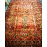 A red ground rug 350 x 248cm