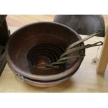 Two circular copper pans and brass saucepans