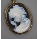 A yellow metal mounted sardonyx cameo pendant brooch, carved with the bust of a young lady to