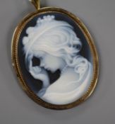 A yellow metal mounted sardonyx cameo pendant brooch, carved with the bust of a young lady to