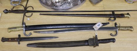 Three late 19th century French bayonets, a US Army bayonet, an EFD 1892 bayonet and an epee