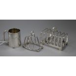 Two silver toastracks (one a.f.) and a silver christening mug.