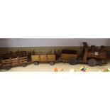 An early 20th century scratch built teak toy locomotive and two wagons overall 123cm