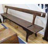 A late Victorian / Edwardian pitch pine railway bench with adjustable back W.273cm