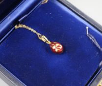 A cased Victor Mayer for Faberge 18ct gold, red enamel and diamond set egg pendant, on 18ct gold