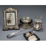 A modern silver coaster, a cased pair of silver napkin rings and other silver and plated items