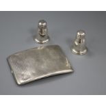 A silver cigarette case and a pair of sterling silver condiments.