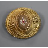 A late Victorian 9ct gold Etruscan style oval brooch, set with coloured stones, gross 3.9 grams,