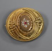 A late Victorian 9ct gold Etruscan style oval brooch, set with coloured stones, gross 3.9 grams,
