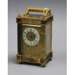 An ornate brass carriage timepiece